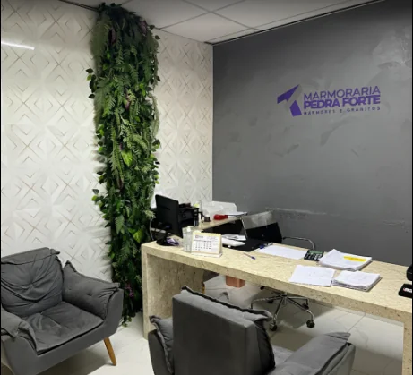 Escritório de atendimento com o logo da Pedra Forte na parede